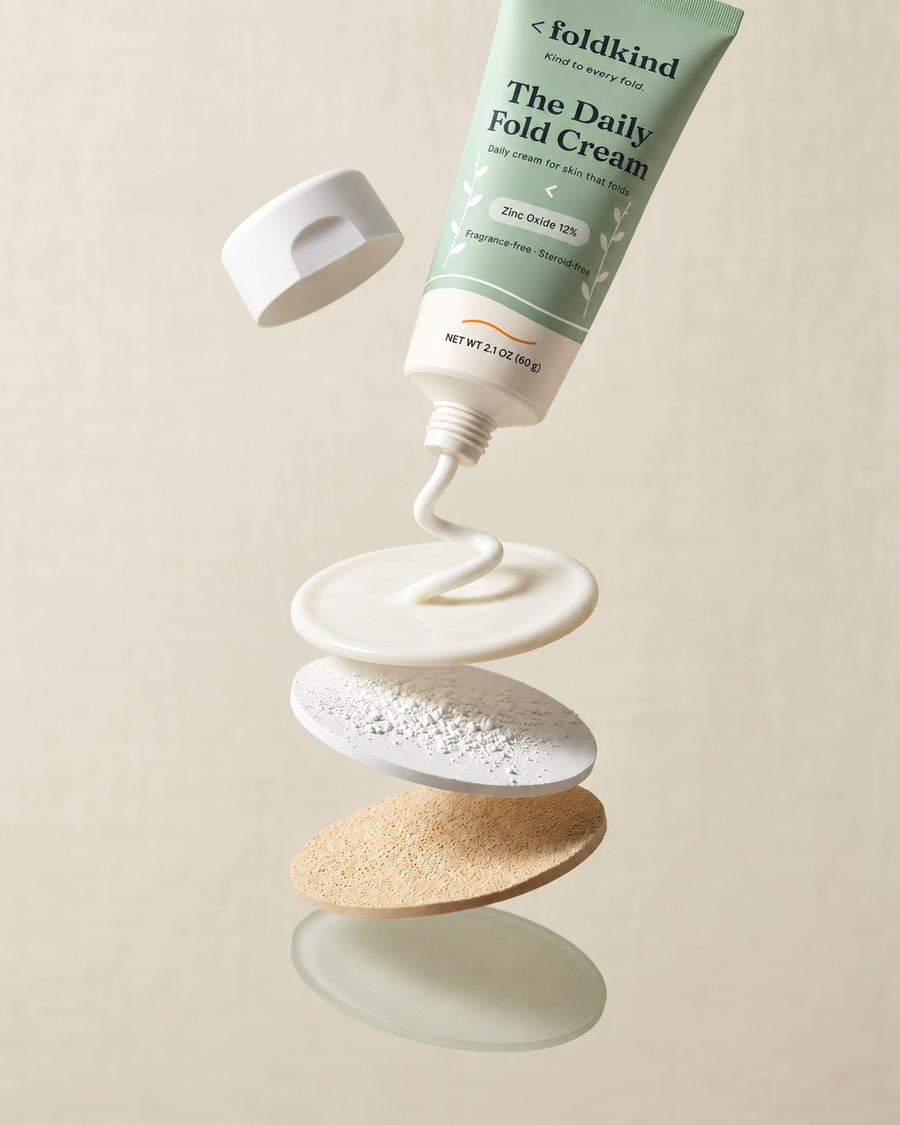 Exploded view of The Daily Fold Cream: the tube, a film of cream, a layer of zinc oxide, and a layer of tapioca starch and silica.